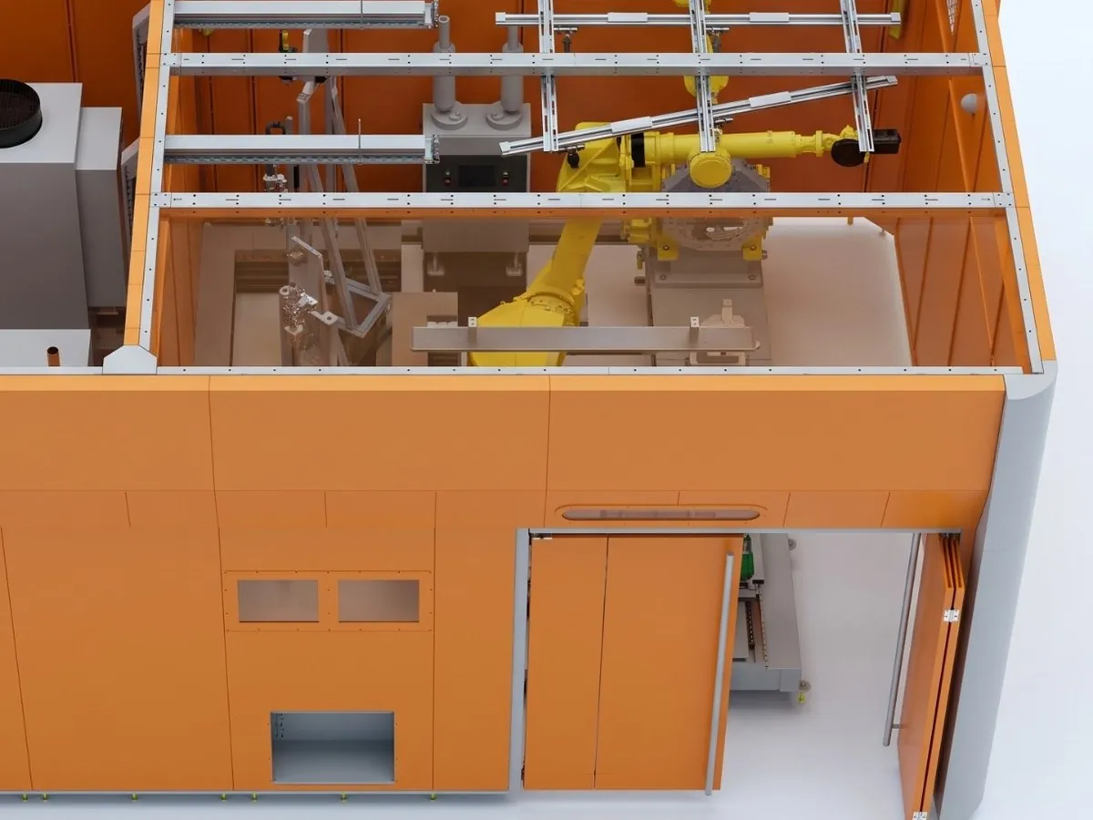 Orange sheet-metal enclosure of a robotic cell, top view